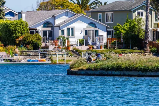Waterfront homes with docks along a seawall-lined canal
